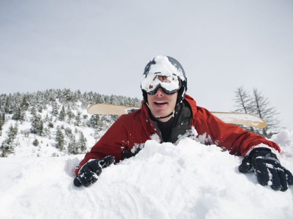 A snowboarder falling