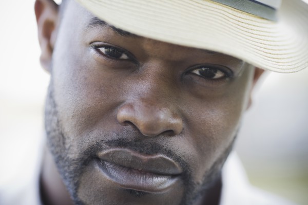 A man outdoors wearing a hat