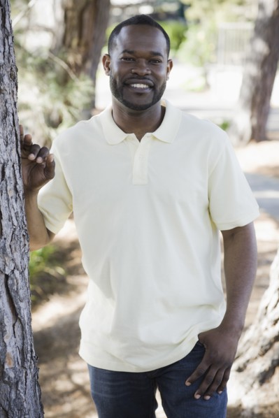A man outdoors by some trees