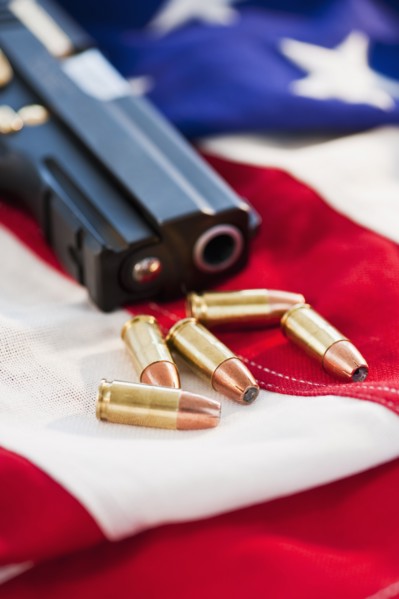 A handgun and ammunition on the American flag