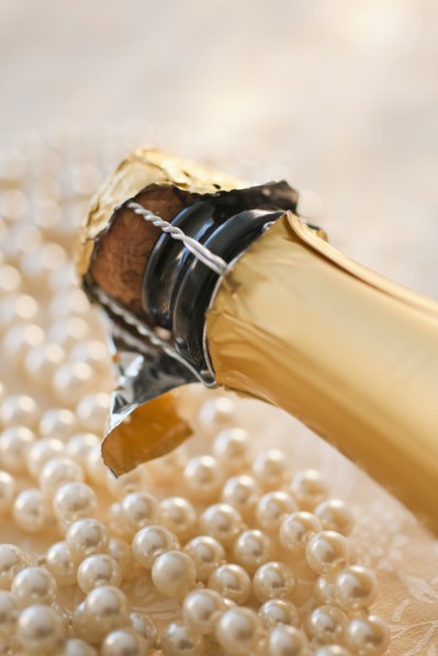 Champagne bottle and pearl necklace.