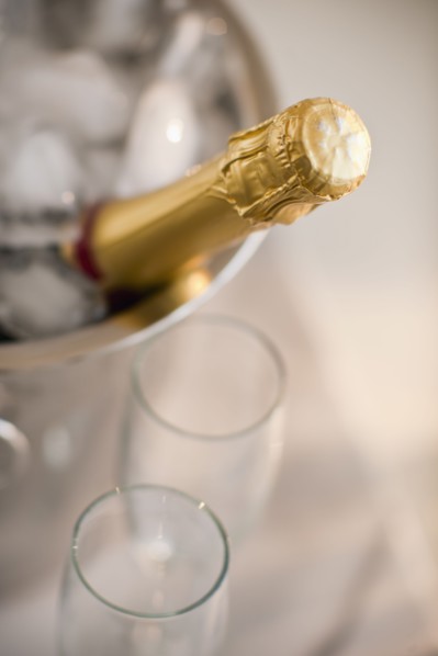 Champagne in a bucket with glasses.