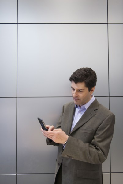 A businessman using a cellular phone.