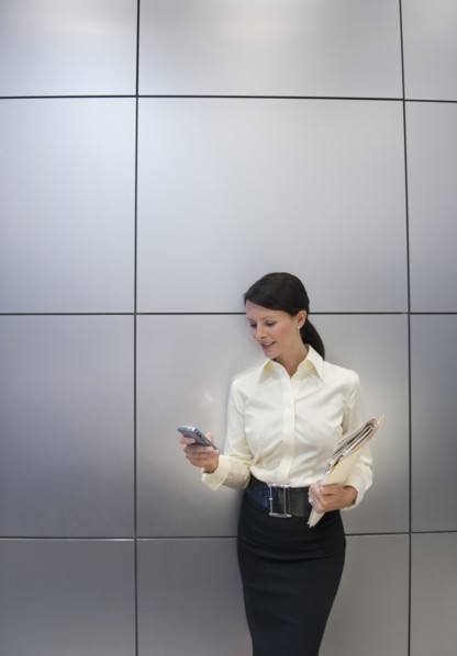 A businesswoman using a personal digital assistant.
