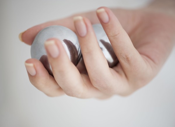 Hand holding Chinese balls.