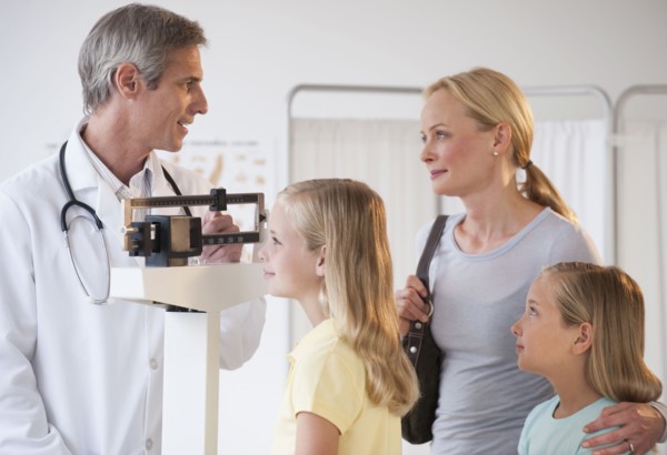 Mother and daughters at Doctor's office.