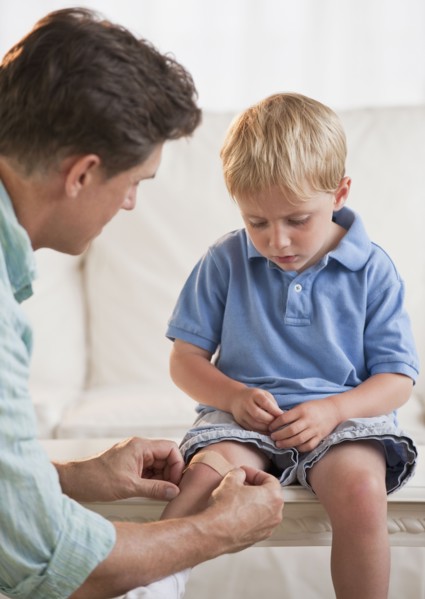 Father treating childs injury.