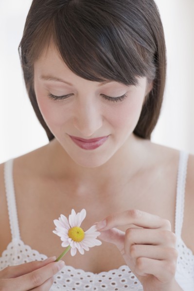 Woman plucking daisy.