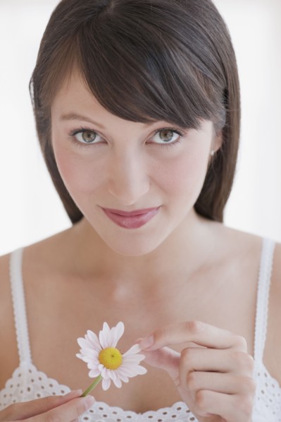 Woman plucking daisy.