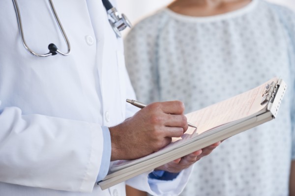 Doctor studying patient chart.