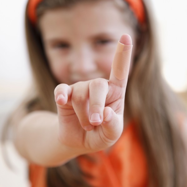 Child showing cut on finger
