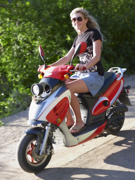 Young woman on scooter