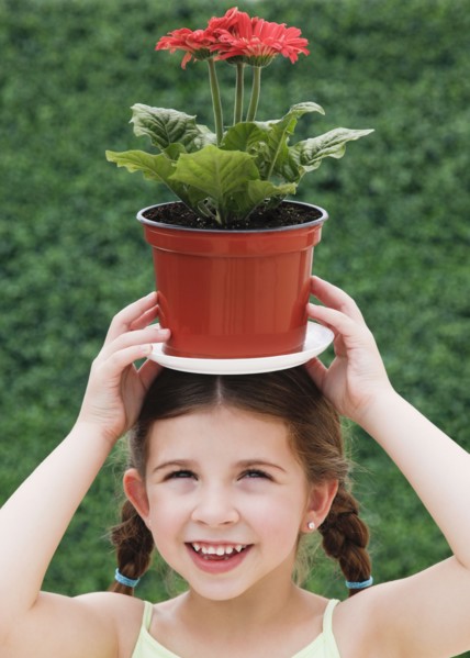 Child with plant on head