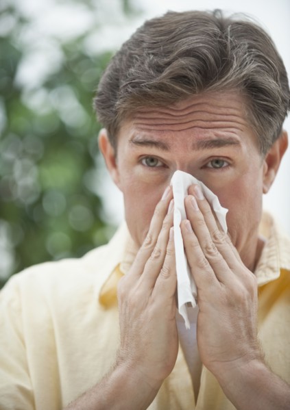 Man blowing nose.