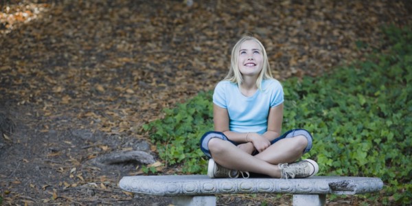 Young girl sitting on bench