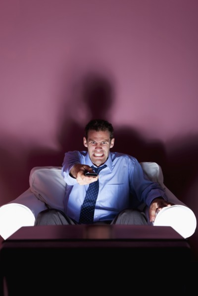 Angry man using remote control