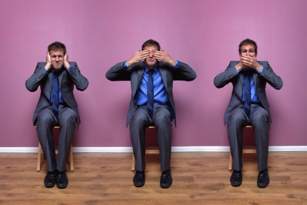 Three businessmen sitting in chairs