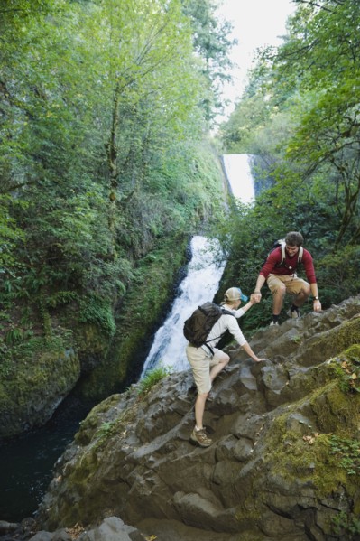 Hikers in front of waterfall
