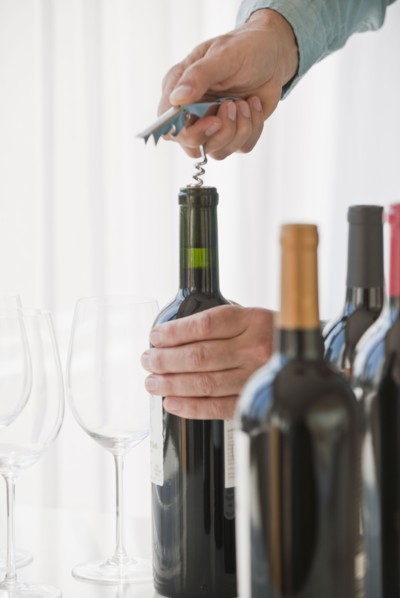 Uncorking wine.