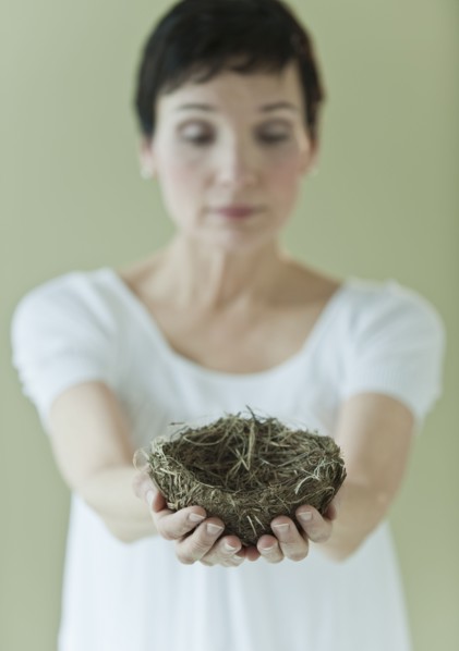 Woman holding nest.