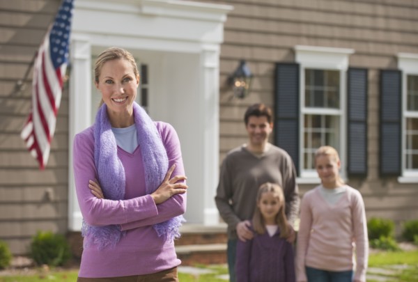Family in front of house.