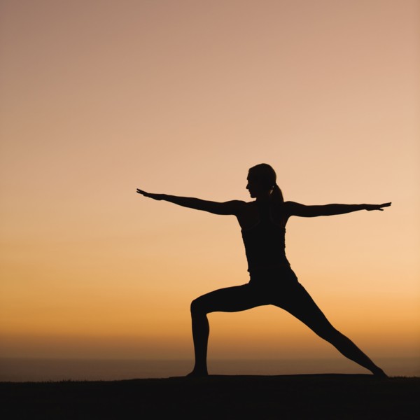 Silhouette of woman doing yoga