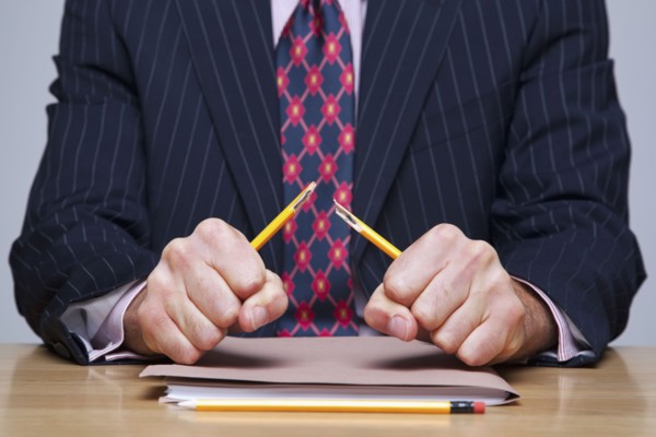 Man breaking pencil