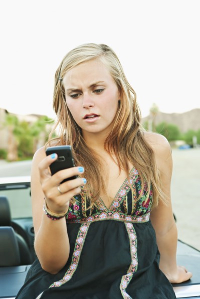 Woman leaning on car