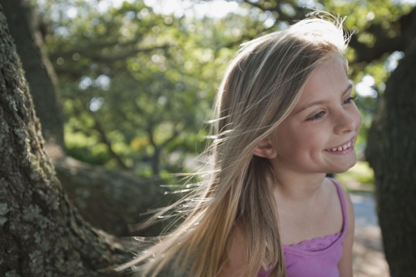 Girl beside tree