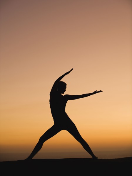 Silhouette of woman doing yoga
