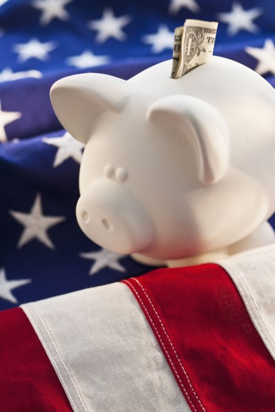 Piggybank on top of American flag.