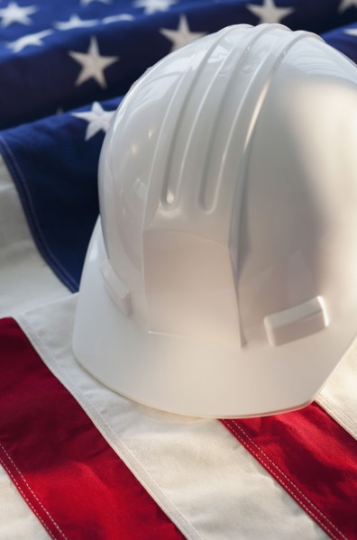 Hard hat on top of American flag.