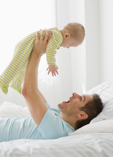 Father and baby playing.