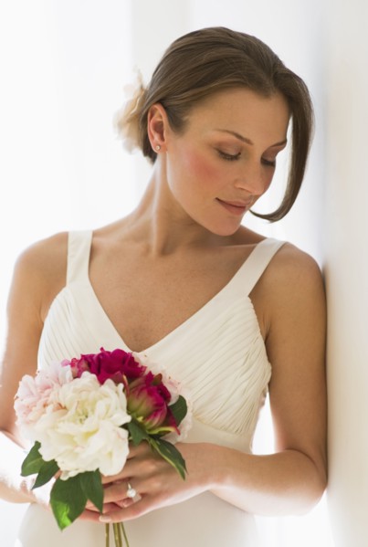Bride holding bouquet of flowers.