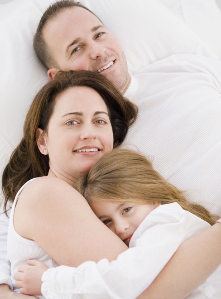 Family cuddling. Photographer: Jamie Grill