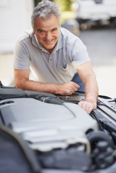 Man looking at car's engine. Photographer: momentimages