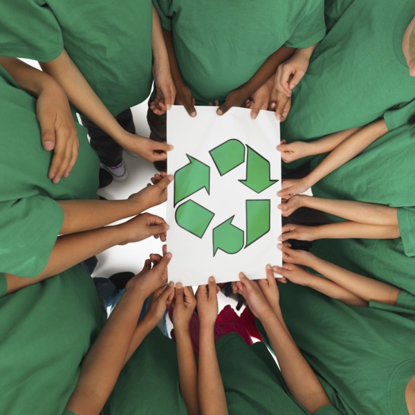 Children holding recycling sign. Photographer: momentimages