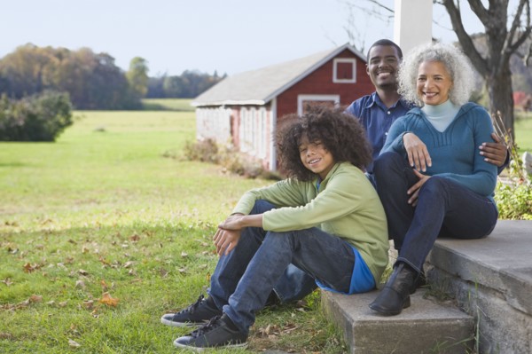 Family sitting on porch. Photographer: Pauline St.Denis