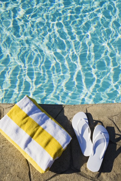 Flip flops and towel by the pool. Photographer: Chris Hackett