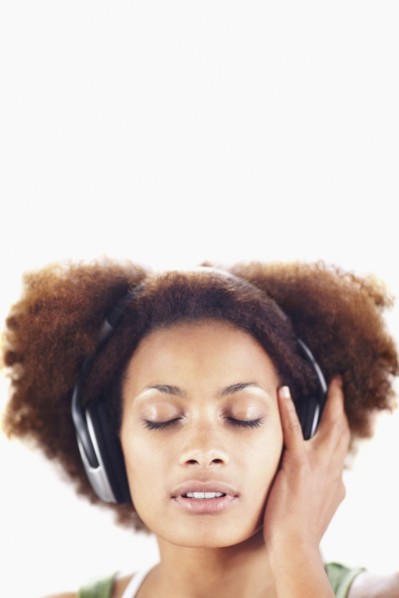 Woman listening to music. Photographer: momentimages