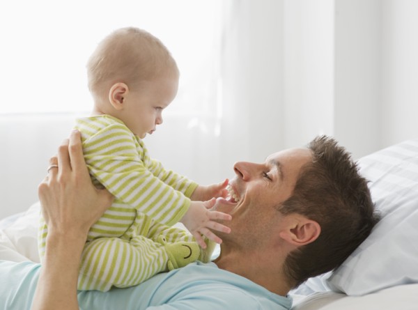 Father and baby playing.