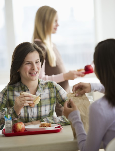 Friends eating in cafeteria.