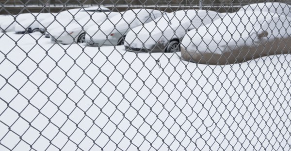 Parking lot behind chain link fence. Photographer: fotog