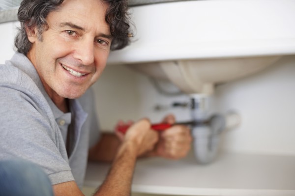 Fixing a leaky sink. Photographer: momentimages