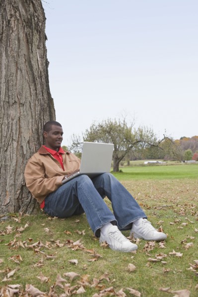 Man using laptop outside. Photographer: Pauline St.Denis