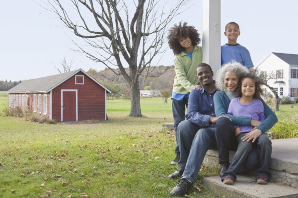 Family sitting on porch. Photographer: Pauline St.Denis