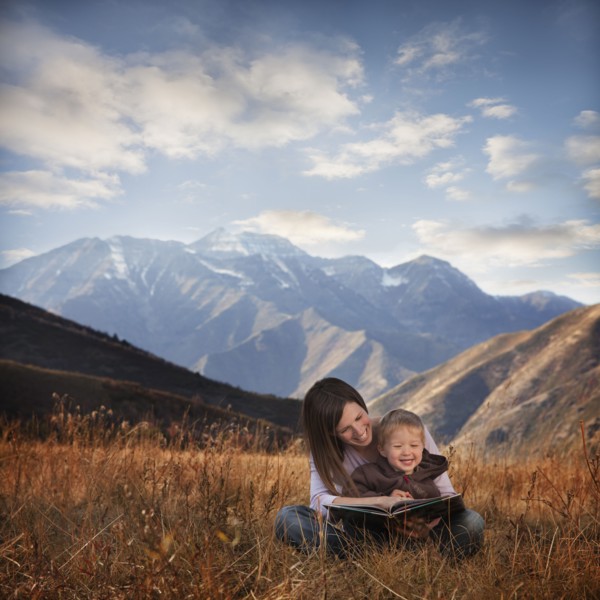 Mother and son reading outdoors. Photographer: Mike Kemp