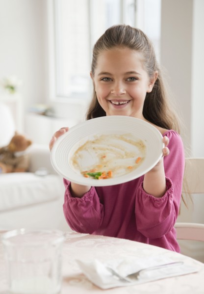 Young girl holding plate. Photographer: Jamie Grill