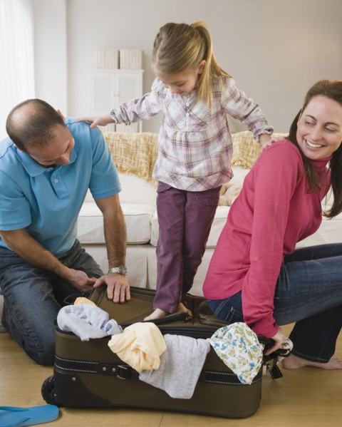 Packing for family vacation. Photographer: Jamie Grill
