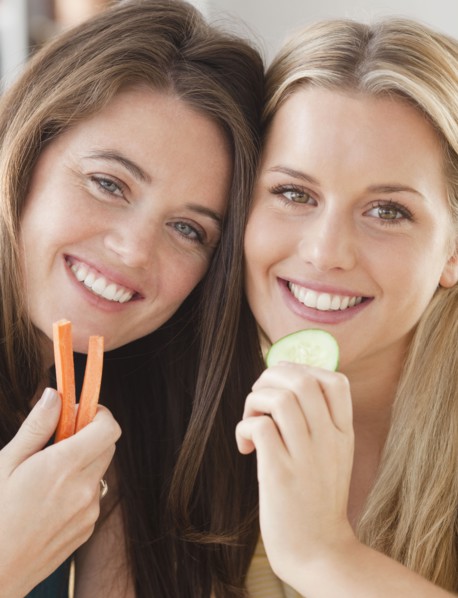 Friends eating vegetables. Photographer: Jamie Grill